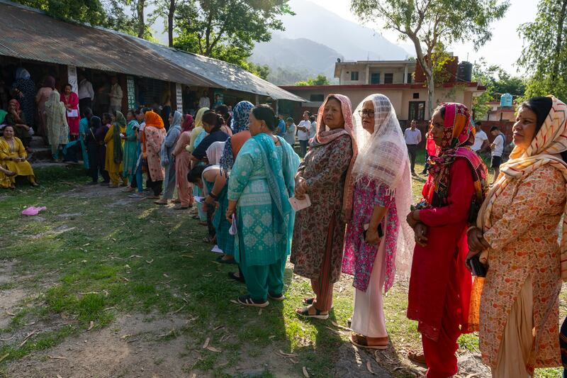 Women in Dharamshala, Himchal Pradesh, queue to cast their votes. AP Photo