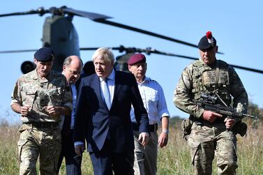 Boris Johnson arrives with Britain's Defence Secretary Ben Wallace (2L) to visit military personnel on Salisbury plain training area near Salisbury, south-west England, September 19, 2019. AFP