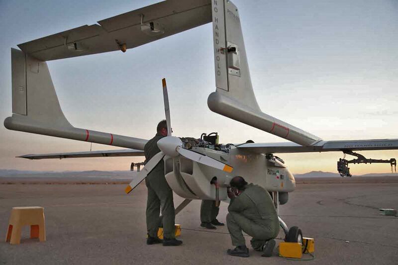 Technicians check an aerial vehicle. AFP