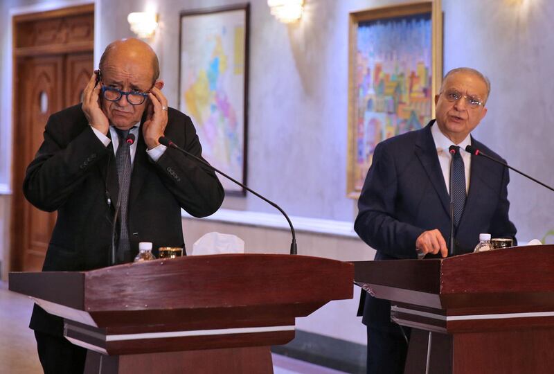 Iraqi Foreign Minister Mohammed Ali al-Hakim (R) and his French counterpart Jean-Yves Le Drian give a press conference in Baghdad on October 17, 2019. France's top diplomat held talks in Baghdad about transferring foreign jihadists from northern Syria, where a Turkish offensive has triggered fears of mass jailbreaks, to be tried in Iraq. European governments are worried that the Turkish operation will allow the escape of some of the 12,000 suspected Islamic State (IS) group fighters -- including thousands of foreigners -- held by Syrian Kurds.
 / AFP / SABAH ARAR
