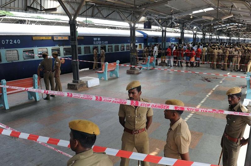 Indian police stand guard at the Chennai train station after two bombs went off in a train arriving from Bangalore on Thursday morning, killing one person and injuring nine others. AFP / May 1, 2014