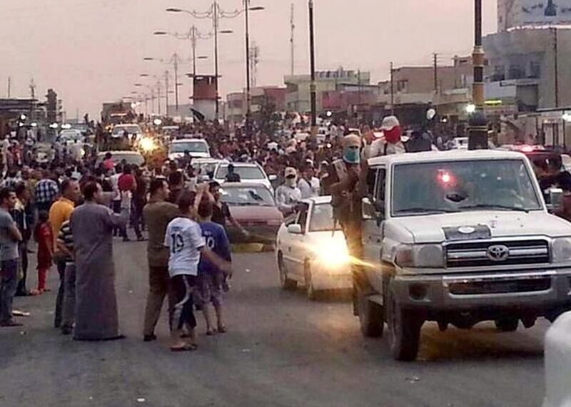 June 11, 2014: Militants parading down a main road in Mosul, posted on a militant Twitter account. AP Photo