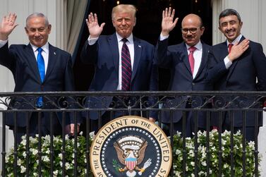 TOPSHOT - (L-R)Israeli Prime Minister Benjamin Netanyahu, US President Donald Trump, Bahrain Foreign Minister Abdullatif al-Zayani, and UAE Foreign Minister Abdullah bin Zayed Al-Nahyan wave from the Truman Balcony at the White House after they participated in the signing of the Abraham Accords where the countries of Bahrain and the United Arab Emirates recognize Israel, in Washington, DC, September 15, 2020. Israeli Prime Minister Benjamin Netanyahu and the foreign ministers of Bahrain and the United Arab Emirates arrived September 15, 2020 at the White House to sign historic accords normalizing ties between the Jewish and Arab states. / AFP / SAUL LOEB