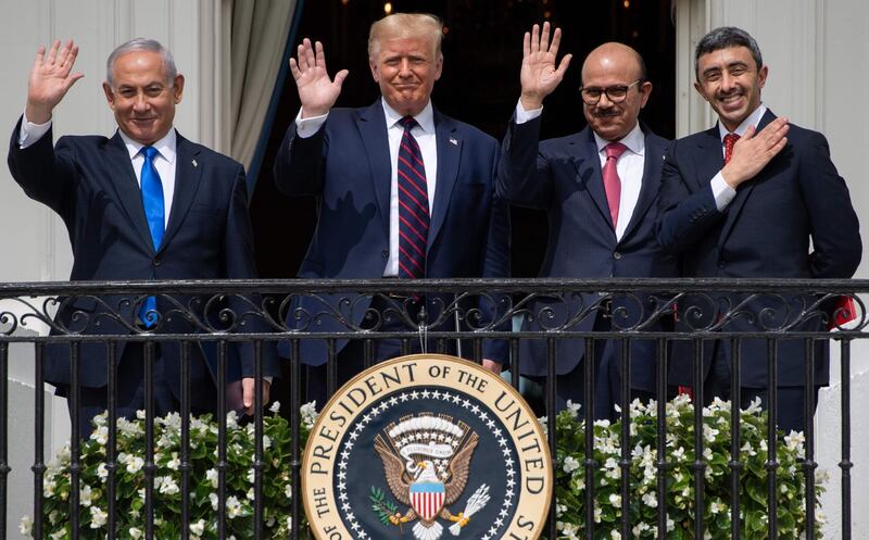 TOPSHOT - (L-R)Israeli Prime Minister Benjamin Netanyahu, US President Donald Trump, Bahrain Foreign Minister Abdullatif al-Zayani, and UAE Foreign Minister Abdullah bin Zayed Al-Nahyan wave from the Truman Balcony at the White House after they participated in the signing of the Abraham Accords where the countries of Bahrain and the United Arab Emirates recognize Israel, in Washington, DC, September 15, 2020. Israeli Prime Minister Benjamin Netanyahu and the foreign ministers of Bahrain and the United Arab Emirates arrived September 15, 2020 at the White House to sign historic accords normalizing ties between the Jewish and Arab states. / AFP / SAUL LOEB
