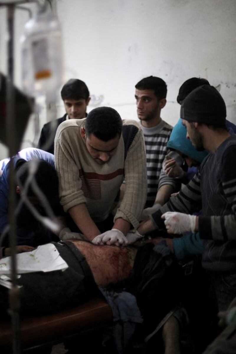 Medics try to resuscitate a man at a makeshift hospital in the rebel-held area of Douma, north-east of the capital Damascus, following reported air strikes by forces loyal to President Bashar Al Assad on February 2. Abd Doumany / AFP
