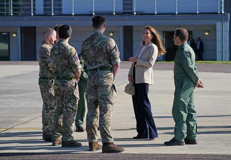 Servicemen and women greeted the Duchess of Cambridge with a salute before she was seen laughing and chatting with them.