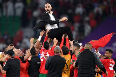 DOHA, QATAR - DECEMBER 10: Walid Regragui, Head Coach of Morocco, celebrates with their team after the team's victory during the FIFA World Cup Qatar 2022 quarter final match between Morocco and Portugal at Al Thumama Stadium on December 10, 2022 in Doha, Qatar. (Photo by Justin Setterfield / Getty Images)