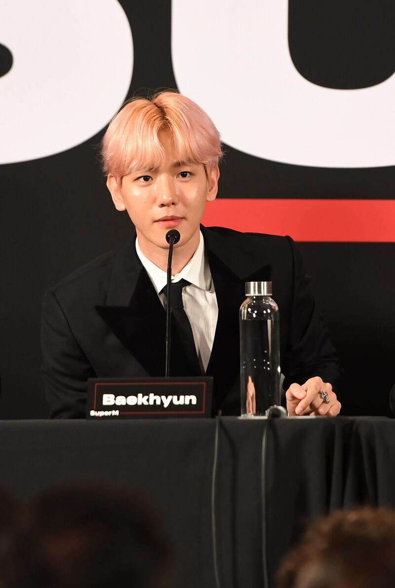 (FromL) Ten, Baekhyun and Lucas of K-pop supergroup SuperM deliver a press conference at the Capitol Records Tower in Hollywood on October 3, 2019. (Photo by VALERIE MACON / AFP)