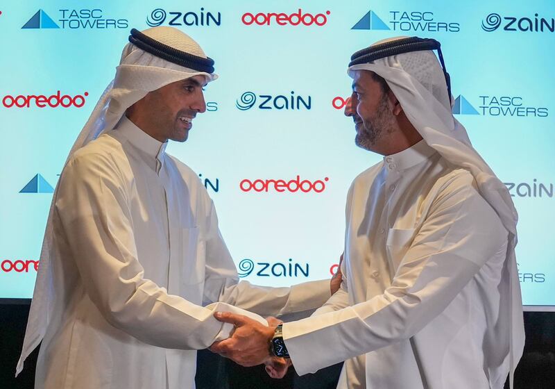 Bader Al Kharafi, vice chairman and group chief executive of Zain Group, left, and Aziz Fakhroo, managing director and group chief executive of Ooredoo, during the signing of the agreements for the Mena region's biggest telecom tower company. Photo: Ooredoo