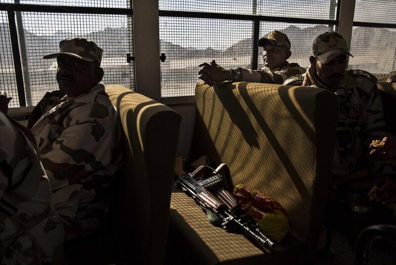 Indian security force soldiers on election duty sit in a bus as they leave a central collection point to head for a polling station.