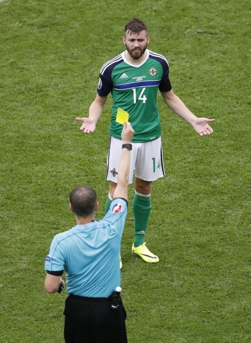 Northern Ireland’s Stuart Dallas is booked by referee Pavel Kralovec. Michael Sohn / AP Photo