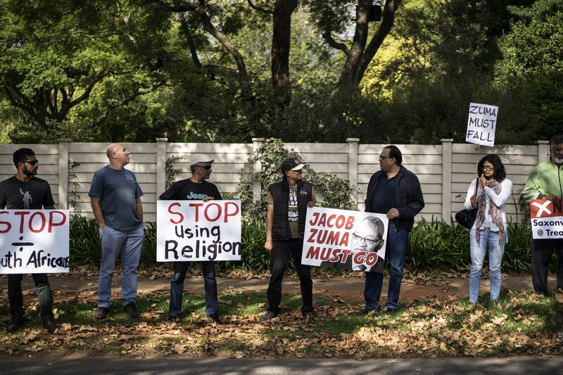 A group of civil society activists protest outside the Gupta compound in Johannesburg's suburb of Saxonwold in April 2017, amid growing concern about the brothers' alleged involvement in state capture. AFP