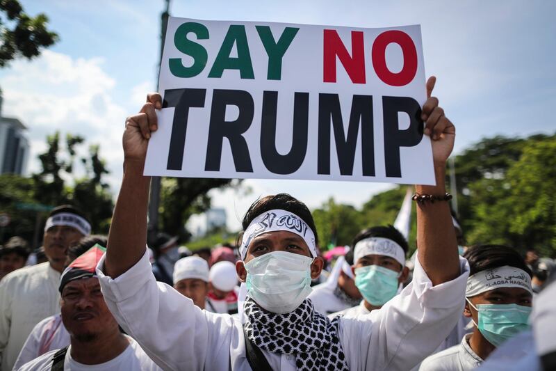 An Indonesian protester holds a placard outside of the US embassy in Jakarta on December 8, 2017. Mast Irham / EPA