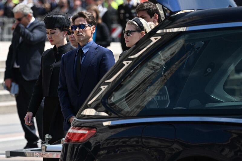 The children of Mr Berlusconi, Eleonora Berlusconi, Pier Silvio Berlusconi and Barbara Berlusconi stand by the hearse. AFP