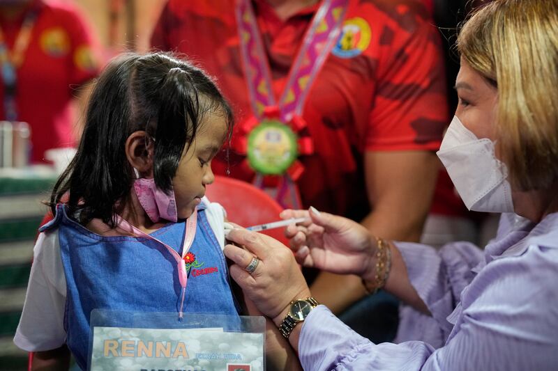 A girl receives her first Covid-19 Pfizer vaccination at San Juan Elementary School. AP Photo
