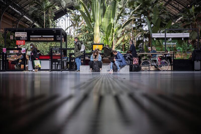 People are seen at Atocha train station in Madrid, Spain. Madrid's region is closing until 9 April due to the rise of coronavirus cases and the beginning of the Easter holidays. EPA