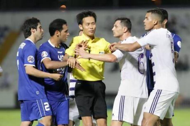 Al Ain players, right, had to be separated from Esteghlal's players by the referee. Jaime Puebla / The National