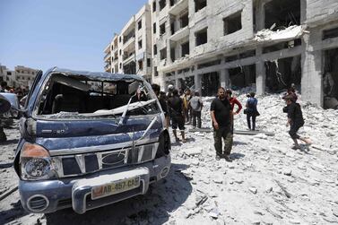 Syrians gather at a site of car bomb in the northwestern Syrian city of Idlib. AFP