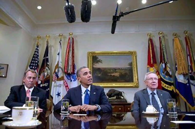 Barack Obama meets the congressional leaders John Boehner, left, and Harry Reid on Friday. Carolyn Kaster / AP Photo