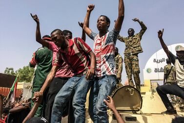 In this April 11, 2019 file photo, Sudanese in Khartoum, Sudan celebrate after President Omar al-Bashir was overthrown. AP