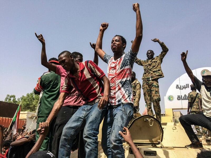 FILE - In this April 11, 2019  file photo, Sudanese celebrate after officials said the military had forced longtime autocratic President Omar al-Bashir to step down after 30 years in power in Khartoum, Sudan. As the uprising against Sudanese President Omar al-Bashir gained strength, Egypt, the United Arab Emirates and Saudi Arabia began reaching out to the military through secret channels to encourage his removal from power. They had long viewed al-Bashir as a problem because of his close ties to Islamists. (AP Photo, File)