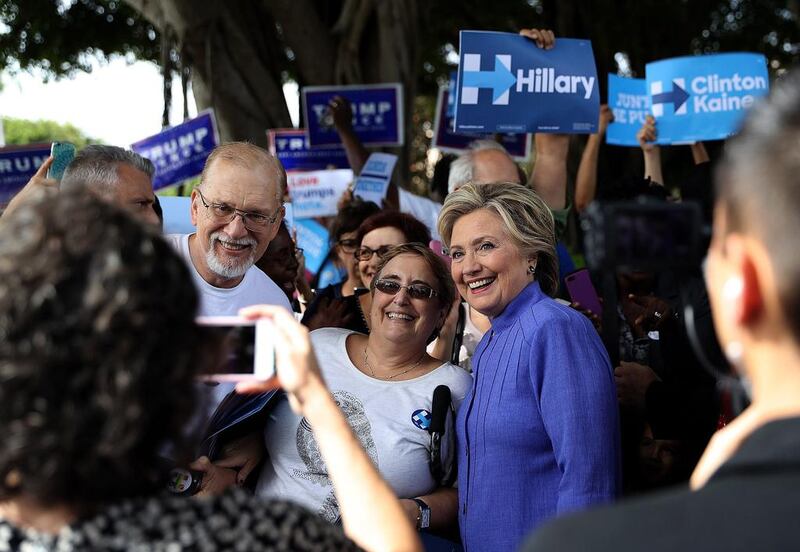 Democratic presidential candidate Hillary Clinton poses with early voters in Pompano Beach, Florida, on October 30, 2016. Justin Sullivan / Getty Images / AFP