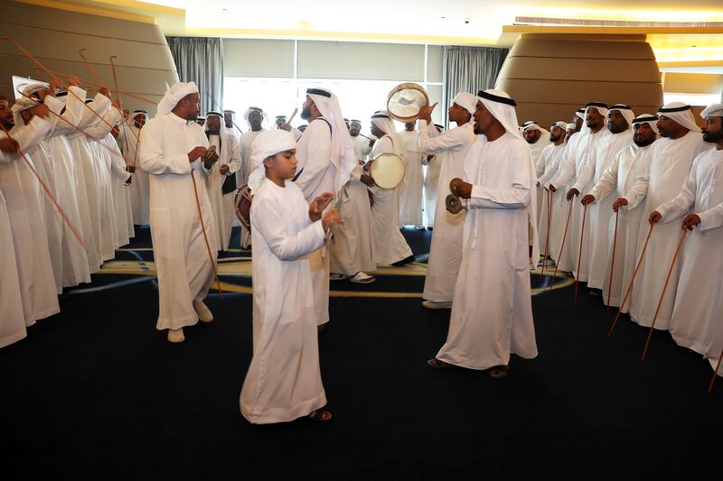 Artists sing folk songs as 100 Emirati grooms prepare for their weddings. Abu Dhabi's latest weddings initiative seeks to rekindle tradition, modesty and community. Pawan Singh / The National
