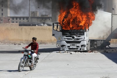 A Turkish lorry burns during protests in Al Bab, in the opposition-held region of Aleppo in northern Syria. AFP