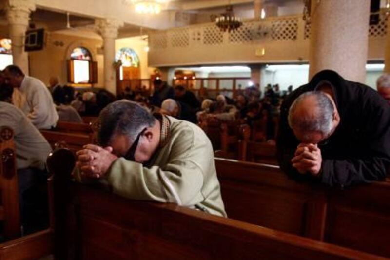 epa02513312 Egyptian Christians pray during Sunday mass at the Christian Coptic church of the Saints where an explosion occured two days earlier, in the northern Egyptian city of Alexandria, Egypt, 02 January 2011. Authorities in Egypt imposed tight security around churches across the country on 02 January, in the wake of a suicide bombing outside a church in Alexandria that killed 21 people and injured nearly 100. The Interior Ministry deployed more heavily-armed police and undercover agents. Checkpoints were set up outside all provinces and cars were being prevented from parking near churches. Shortly after midnight 31 December, a suicide bomber detonated his nail-packed bomb outside the Coptic Christian Church of the Saints in the northern city of Alexandria where hundreds were attending a New Year's Eve service.  EPA/AHMED KHALED *** Local Caption ***  02513312.jpg