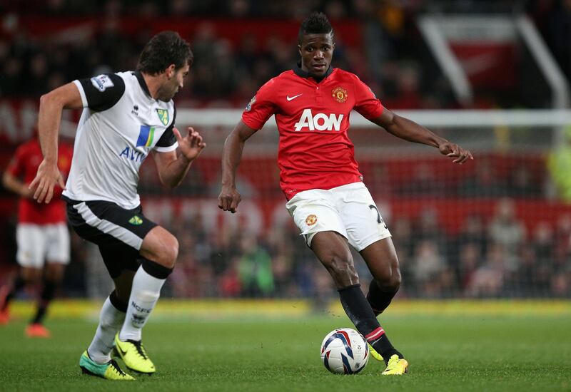 MANCHESTER, ENGLAND - OCTOBER 29:  Wilfried Zaha of Manchester United attempts to move past Javier Garrido of Norwich City during the Capital One Cup Fourth Round match between Manchester United and Norwich City at Old Trafford on October 29, 2013 in Manchester, England.  (Photo by Clive Brunskill/Getty Images)