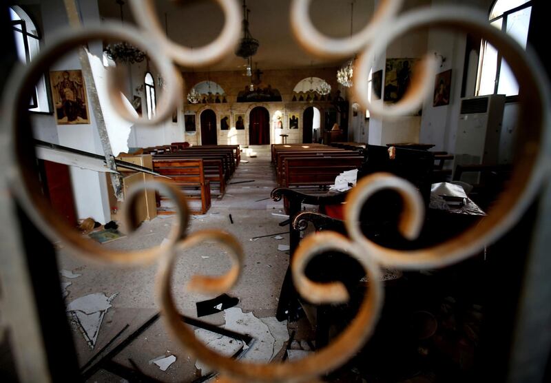 The altar of Judeida church is seen damaged by mortar shell, at the Christian village of Judeida, in Idlib province, Syria. The Qatar-based Syrian Network for Human Rights, a Syrian war monitor associated with the opposition said in its report, that over 120 Christian places of worship have been damaged or destroyed by all sides in the country’s eight-year conflict.  AP