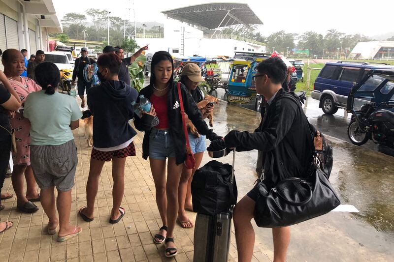 Local tourists with their belongings arrive to take shelter at a sports complex turned into an evacuation centre in Dapa town, Siargao island. Photo: AFP