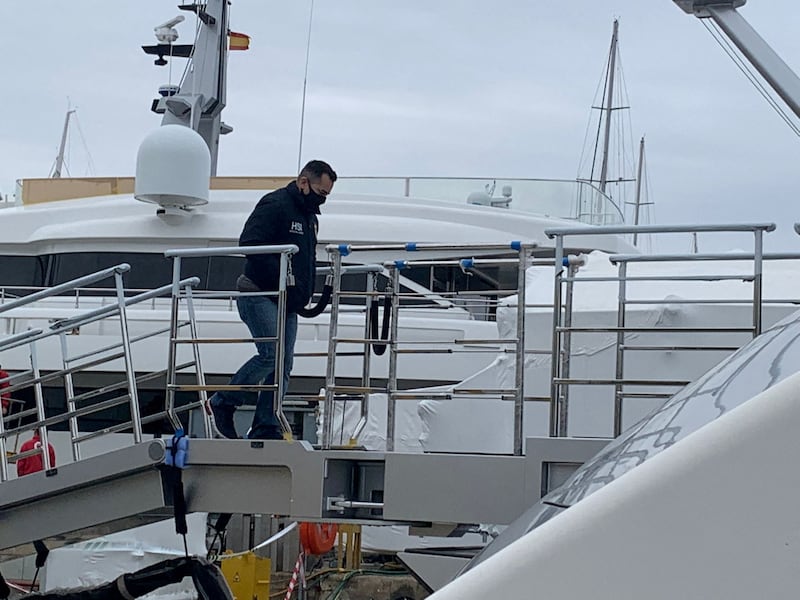 A US Homeland Security Police agent climbs on board the 'Tango' superyacht, belonging to Russian oligarch Viktor Vekselberg, which was seized on behalf of US authorities, as it is docked in Mallorca, Spain. Reuters
