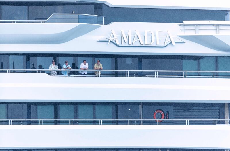 Crew members look on as the yacht 'Amadea', belonging to Russian oligarch Suleiman Kerimov and seized by the Fiji government at the request of the US, arrives at Honolulu Harbour, Hawaii. AFP