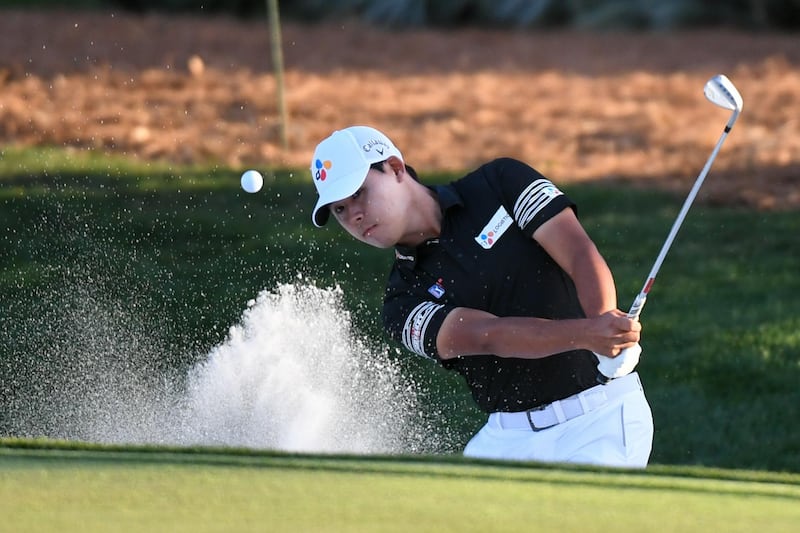 Si Woo Kim hits out of sand onto the ninth green. USA Today