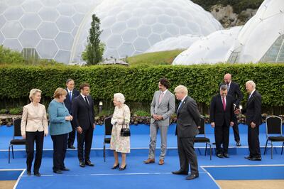 European Commission President Ursula von der Leyen, German Chancellor Angela Merkel, Japan's Prime Minister Yoshihide Suga, France's President Emmanuel Macron with Britain's Queen Elizabeth, Canada's Prime Minister Justin Trudeau,  Britain's Prime Minister Boris Johnson, Italy's Prime Minister Mario Draghi, U.S. President Joe Biden and European Council President Charles Michel prepare for a group photo during a drinks reception on the sidelines of the G7 summit, at the Eden Project in Cornwall, Britain June 11, 2021. Jack Hill/Pool via REUTERS