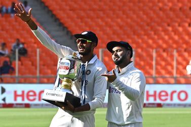 India's Axar Patel (L) and teammate Rishabh Pant pose with the trophy after winning the test series against England at the end of their fourth Test cricket match at the Narendra Modi Stadium in Motera on March 6, 2021. IMAGE RESTRICTED TO EDITORIAL USE - STRICTLY NO COMMERCIAL USE / AFP / Sajjad HUSSAIN / IMAGE RESTRICTED TO EDITORIAL USE - STRICTLY NO COMMERCIAL USE