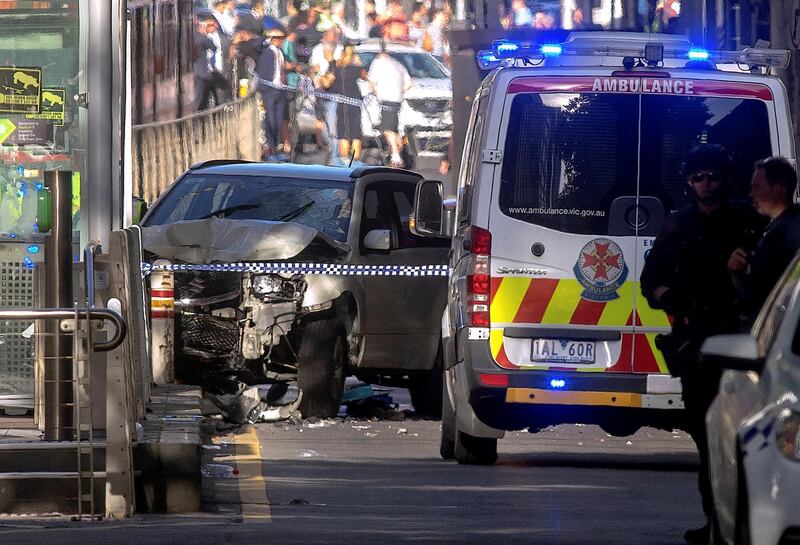 FILE PHOTO - Australian police stand near a crashed vehicle after they arrested the driver of a vehicle that had ploughed into pedestrians at a crowded intersection near the Flinders Street train station in central Melbourne, Australia, December 21, 2017.      REUTERS/Luis Ascui/File photo