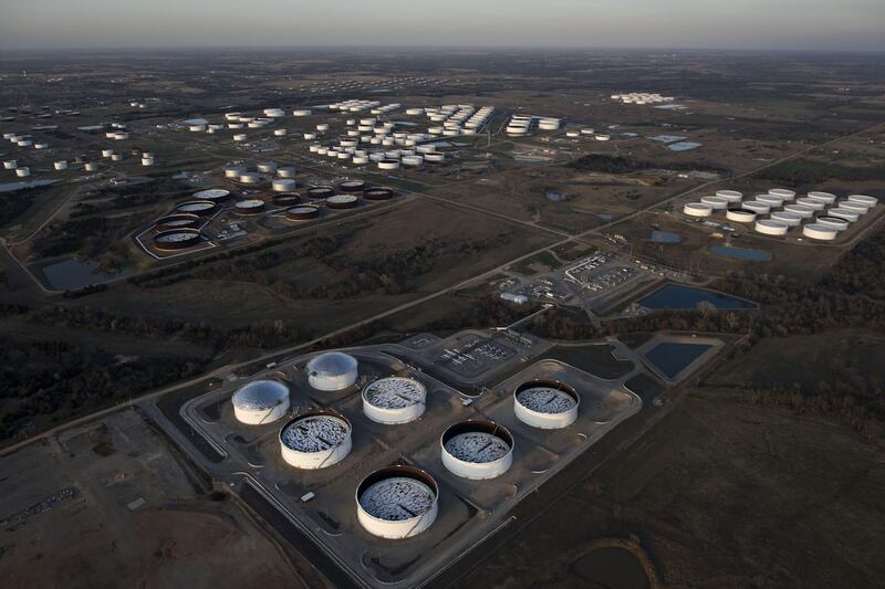 Oil storage tanks stand in this aerial photograph taken above Cushing, Oklahoma, U.S., on Tuesday, March 24, 2015. The fastest oil-inventory growth on record at the main U.S. hub may be about to end, easing concern that storage limits will be strained. Photographer: Daniel Acker/Bloomberg