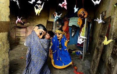 Children dressed in puppet costumes play at the Kathputli Colony in New Delhi. The name Kathputli comes from the Hindi word for puppet. AFP
