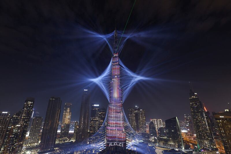 Light is projected from the Burj Khalifa just before the new year fireworks show begins. Reuters