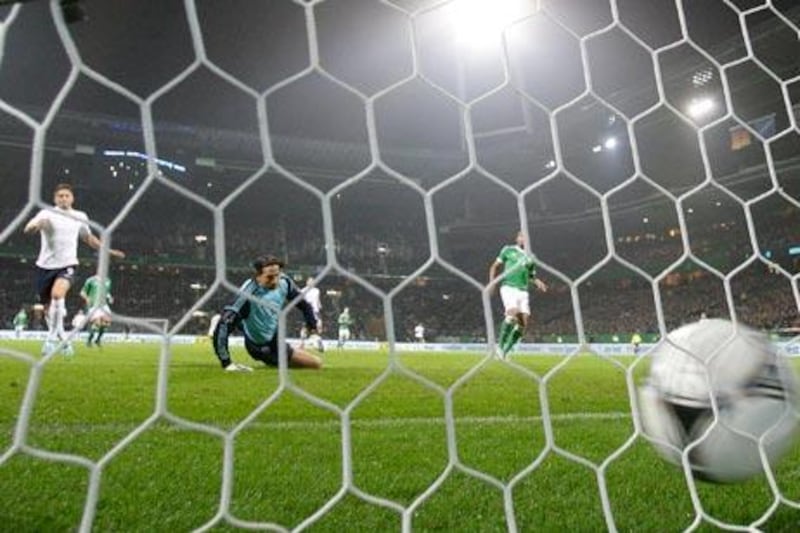 France's  Olivier Giroud, left, scores against Germany's goalkeeper Tim Wiese in the friendly match. France won 2-1.