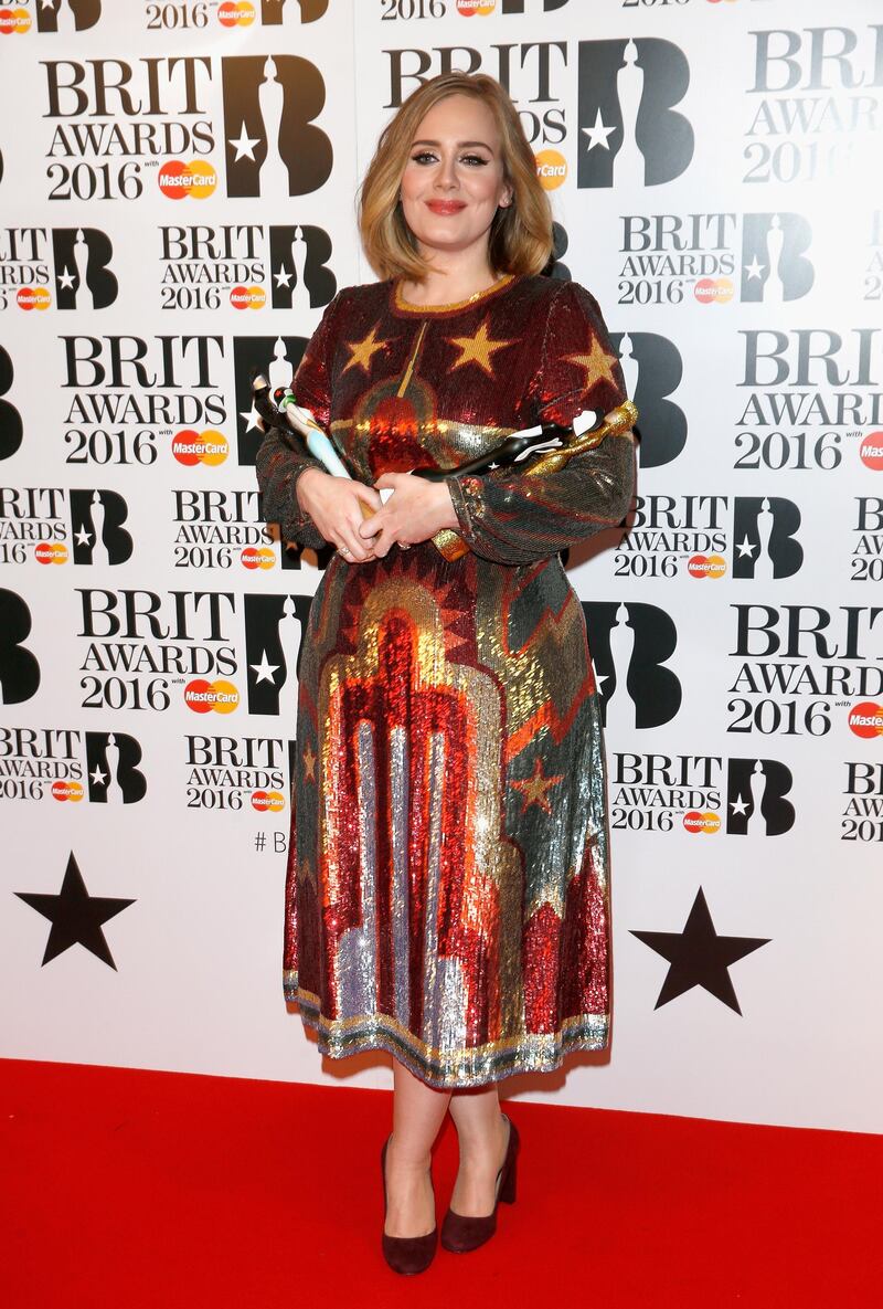LONDON, ENGLAND - FEBRUARY 24: (EDITORIAL USE ONLY)  Adele poses in the winners room at the BRIT Awards 2016 with her 4 Brit awards at The O2 Arena on February 24, 2016 in London, England.  (Photo by Luca Teuchmann/Getty Images)