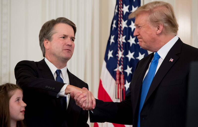 TOPSHOT - US Judge Brett Kavanaugh (L) shakes hands with US President Donald Trump after being nominated to the Supreme Court in the East Room of the White House on July 9, 2018 in Washington, DC.  / AFP / SAUL LOEB
