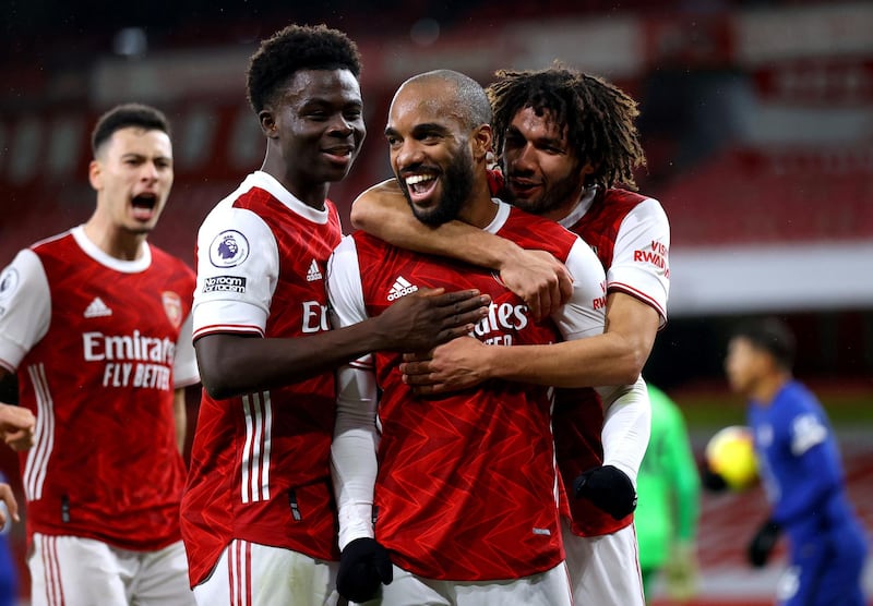 Alexandre Lacazette is mobbed by teammates after opening the scoring in Arsenal's 3-1 victory over Chelsea at the Emirates Stadium on Saturday, December 26. PA