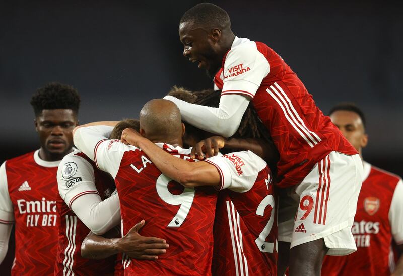 Arsenal players celebrate after Arsenal's Willian scored his side's third goal during the English Premier League soccer match between Arsenal and West Bromwich Albion at the Emirates Stadium in London, England, Sunday, May 9, 2021. (Richard Heathcote/ Pool via AP)
