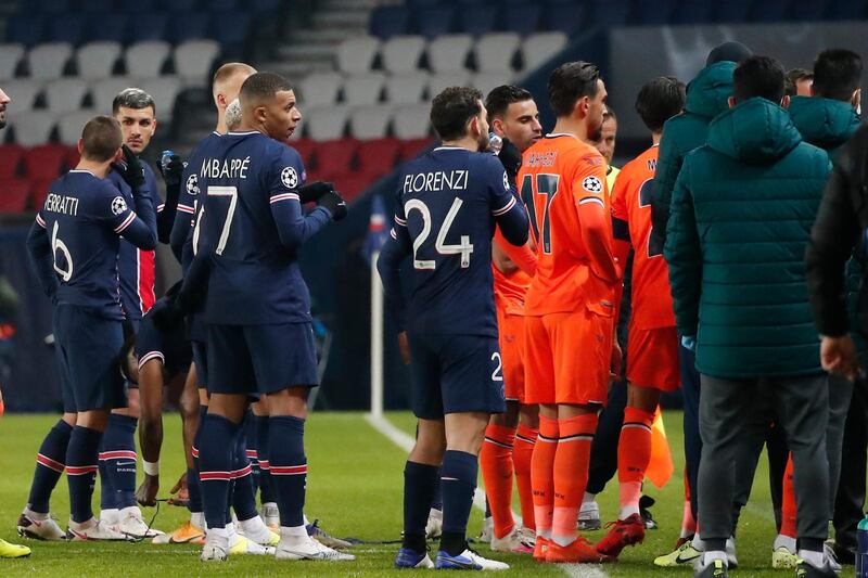 Players of Paris Saint Germain, and Istanbul Basaksehir leave the pitch after the match was suspended following allegations of racist language used by one of the match officials. PA