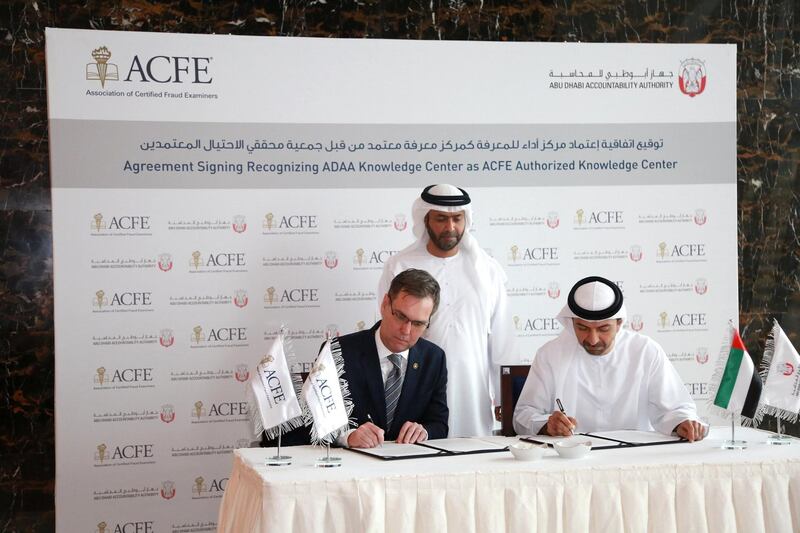 Bruce Dorris, the US-based president and chief executive of the Association of Certified Fraud Examiners (left) signs an agreement with Hamad Al Hurr Al Suwaidi (right), chairman of the Abu Dhabi Accountability Authority, to certify the AADA's fraud identification courses. Courtesy of Abu Dhabi Accountability Authority