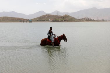 A boy cools off his horse in the Qargha Lake, on the outskirts of Kabul, Afghanistan April 20, 2021.REUTERS/Mohammad Ismail