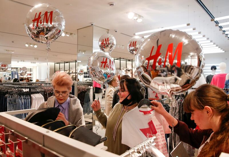 FILE PHOTO: People shop at the Swedish fashion retailer Hennes & Mauritz (H&M) store on its opening day in central Moscow, Russia, May 27, 2017. REUTERS/Maxim Shemetov /File Photo